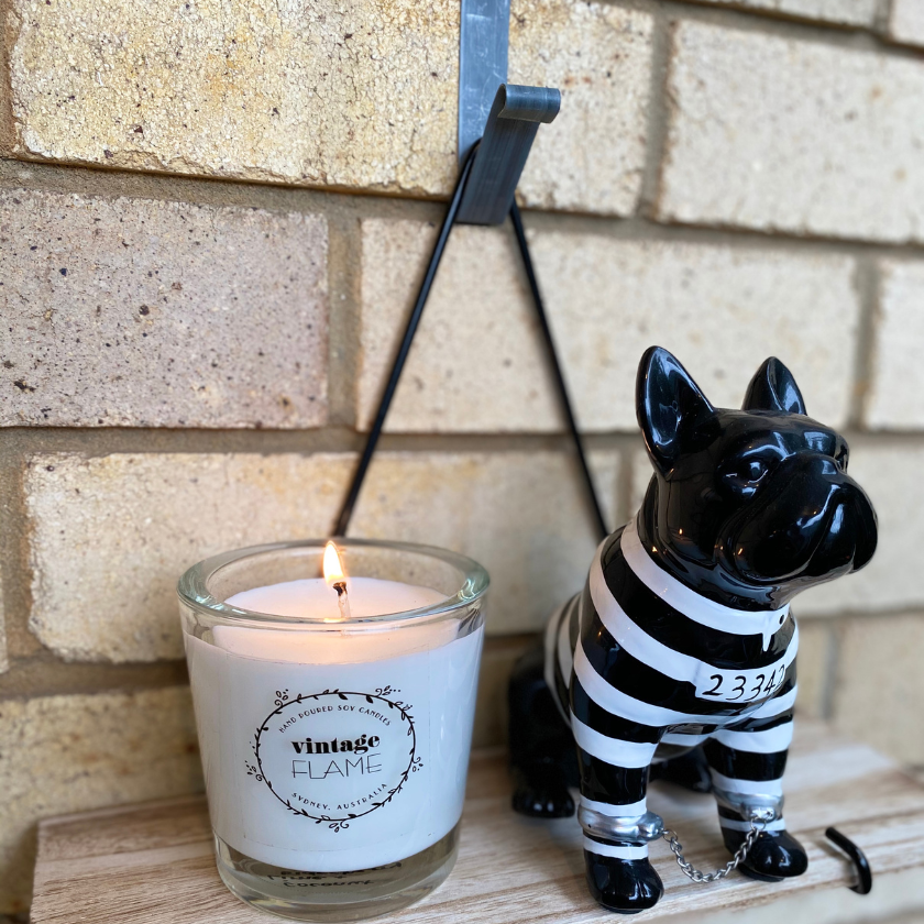 Candle and dog decor hanging on the wall using Brick Grips' Brick Hanger. This tool is easy to install! No tools and drilling needed.