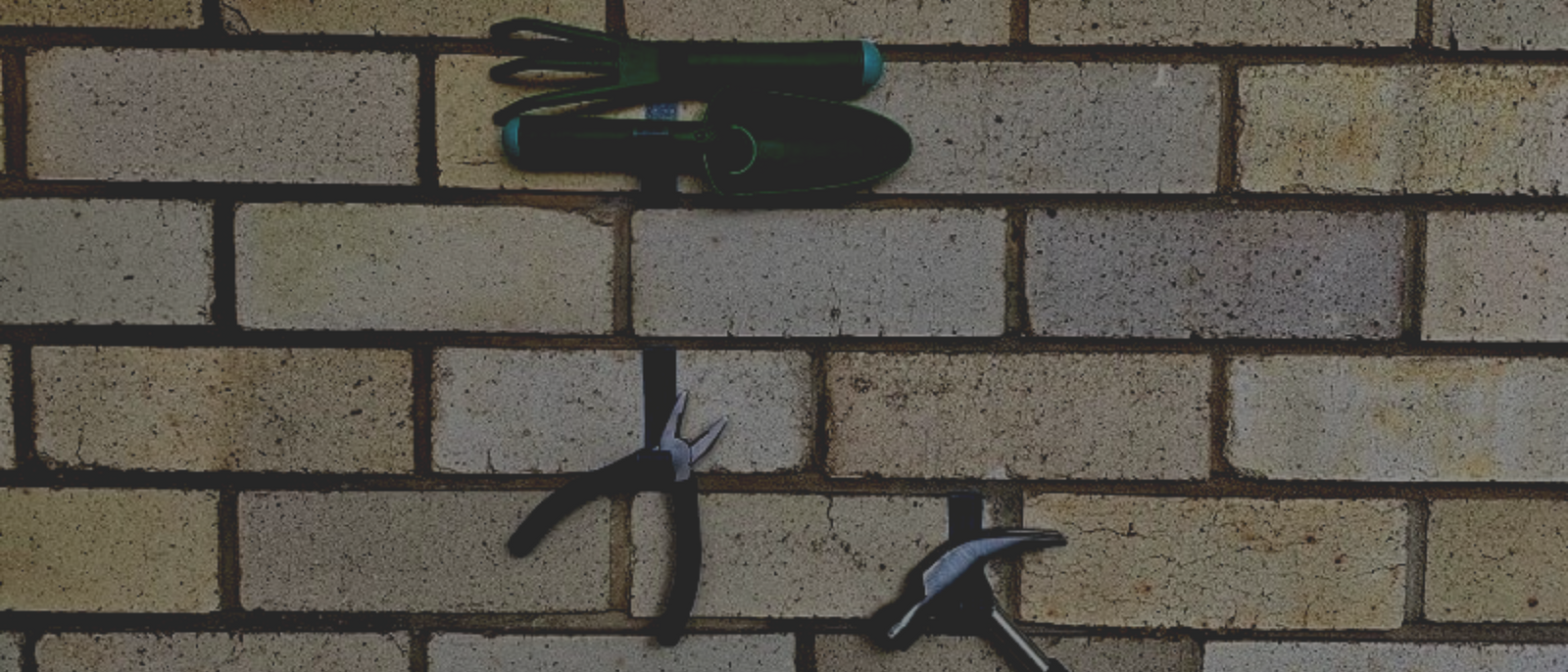 Home tools hanging on the wall with Brick Grips' strongest Brick Hanger.