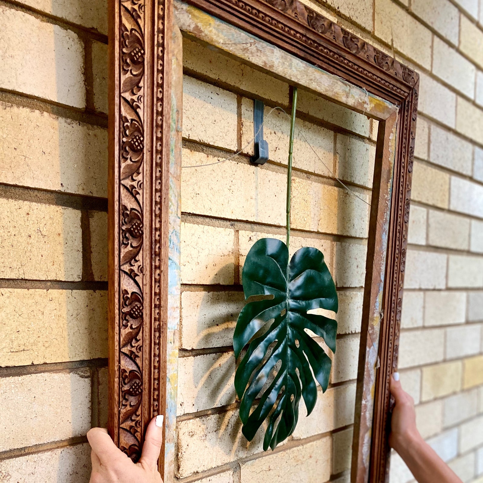 Brick wall with a wood frame and leave using our brick hanger to provide for your home decoration needs.