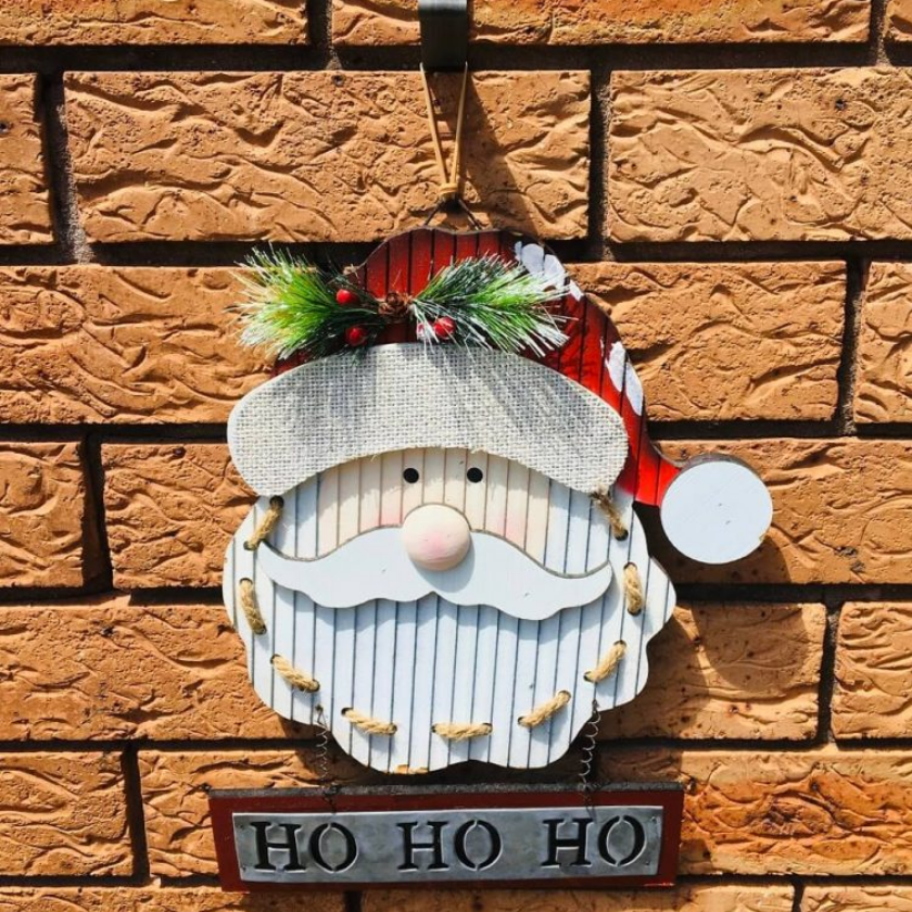 Holiday Santa decoration hanging on the brick wall using the Brick Grips' Brick Hook.