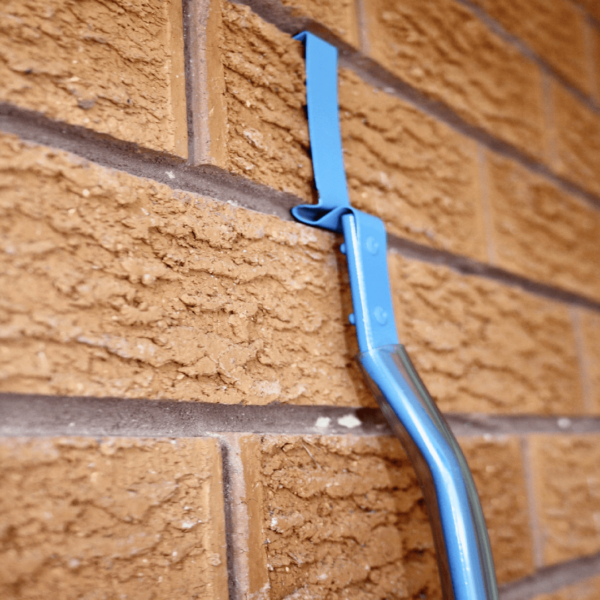 Brick wall with blue surfboard hanger