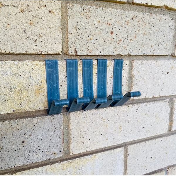 Brick wall with five blue brick hanger